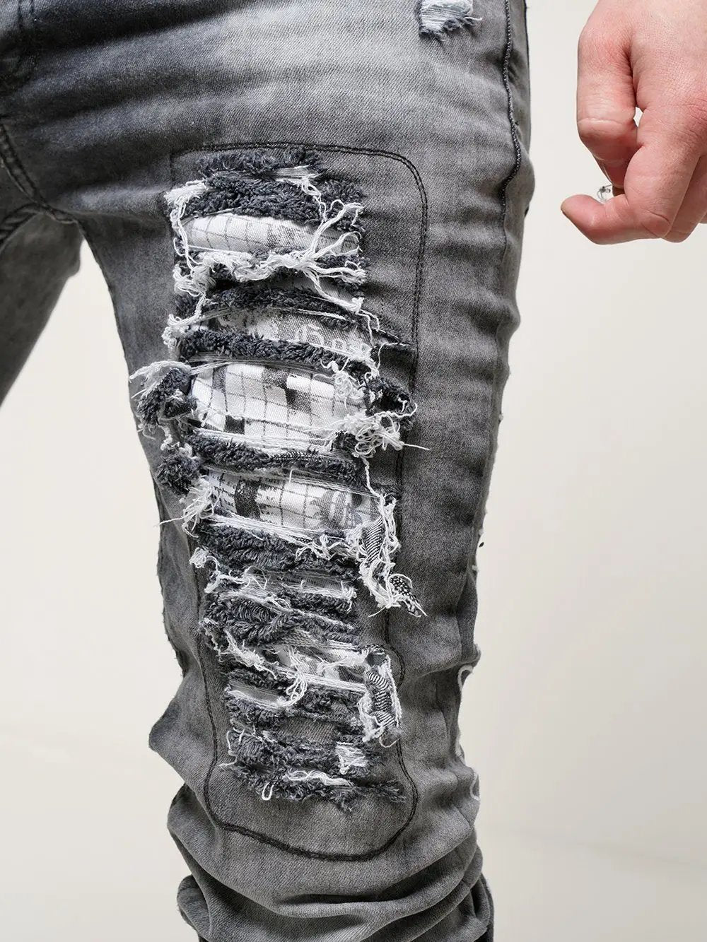 Close up shot of rip and patch on the skinny streetwear jeans called THE OUTLAW Jeans by SERNES