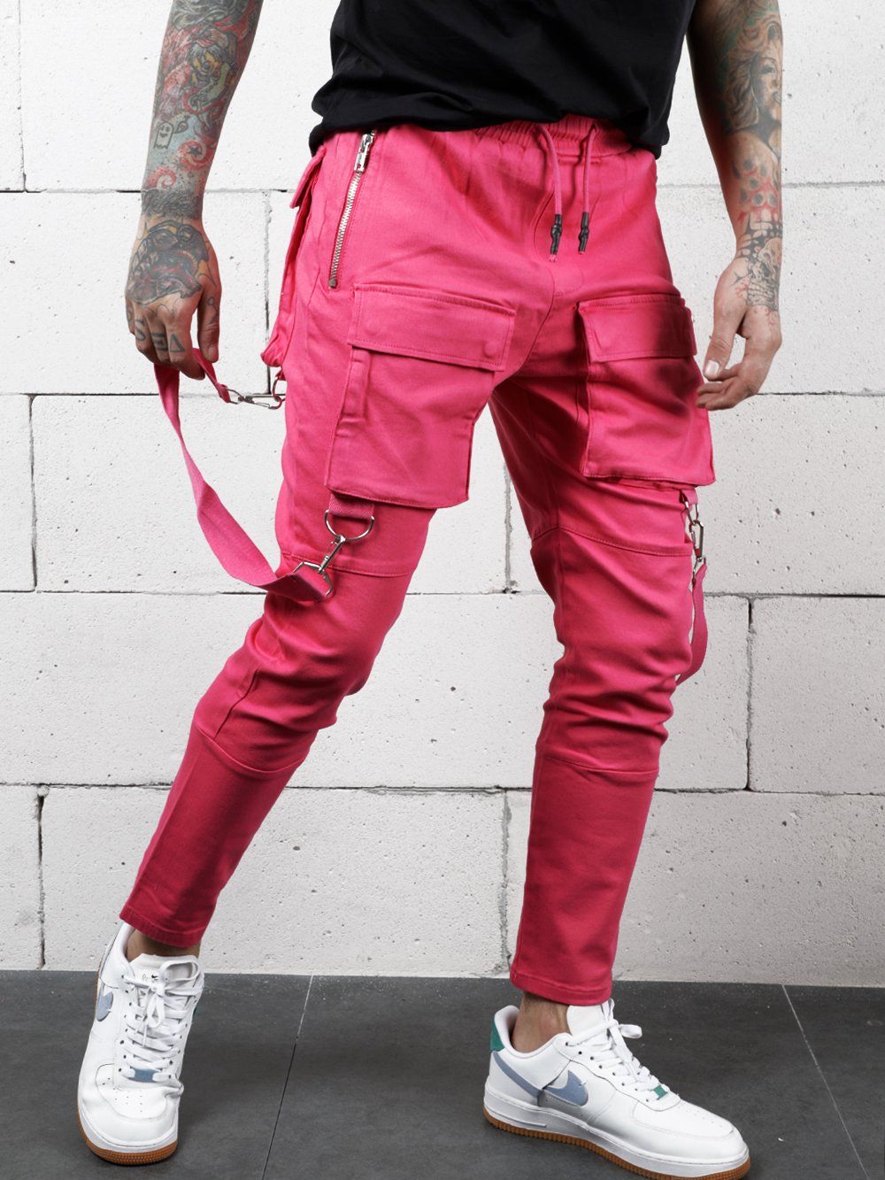 A man wearing the PINK BRONX cargo pants with zippers.