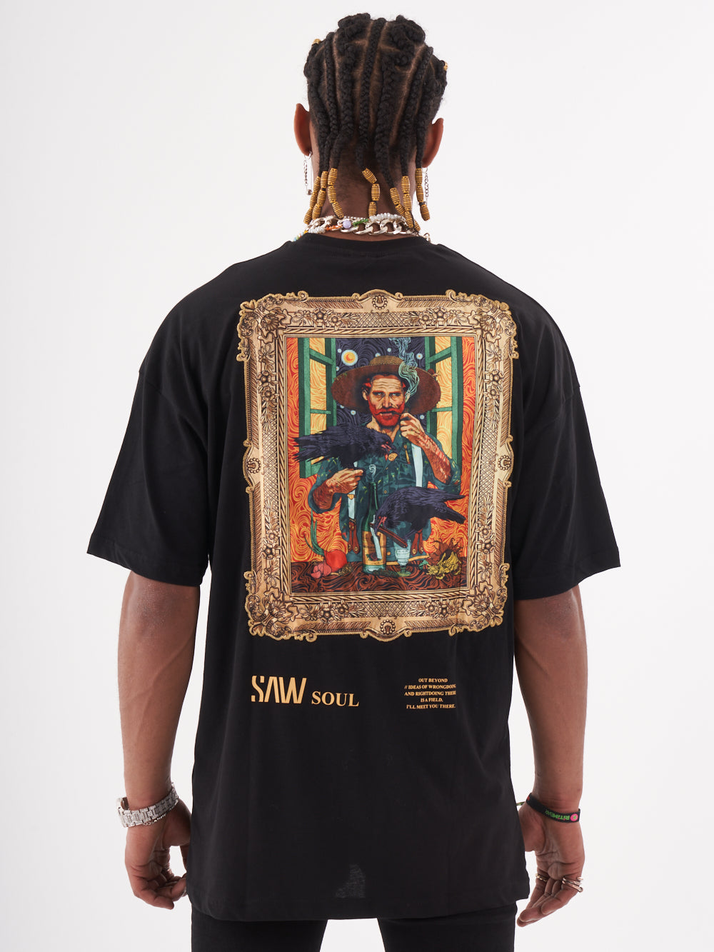 The back of a man wearing a black VINCENT T-SHIRT with a painting on it.
