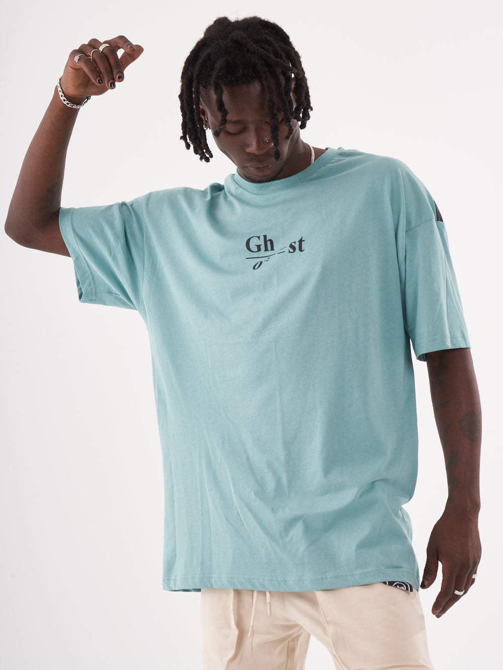 A man wearing a blue Ghost T-shirt with the word gi on it.