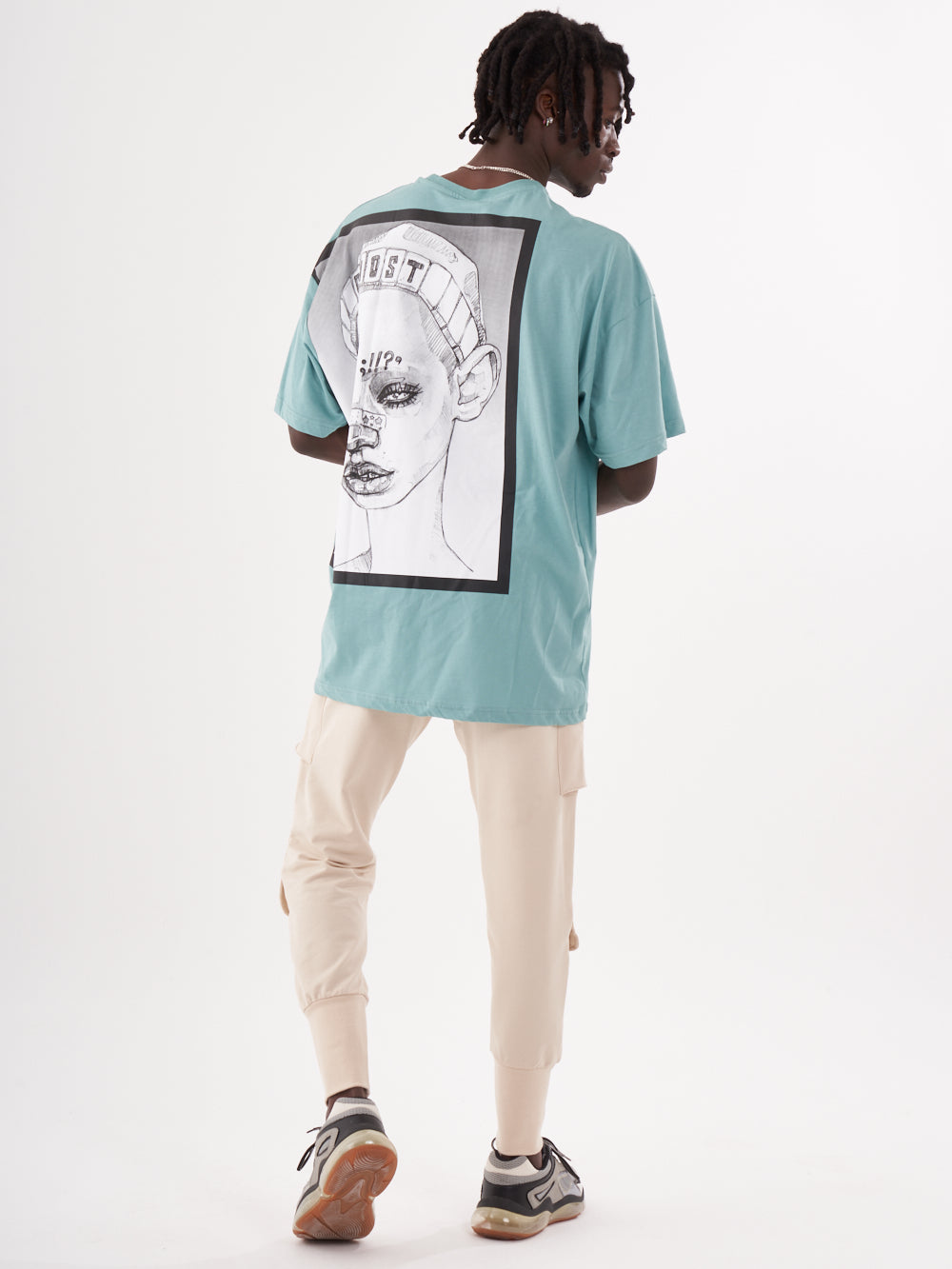 The back of a man wearing a GHOST T-SHIRT with an image of a woman.