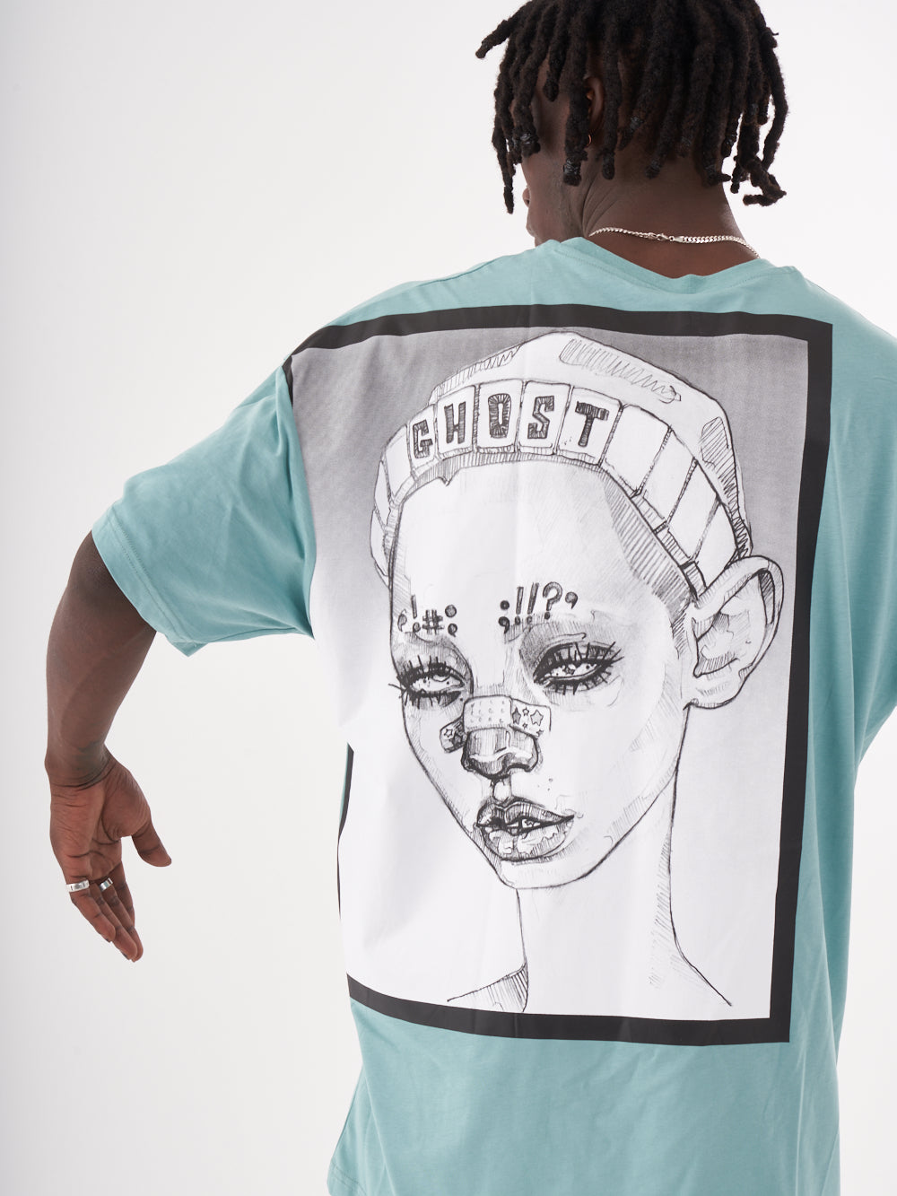 The back of a man wearing a GHOST T-SHIRT with a drawing on it.