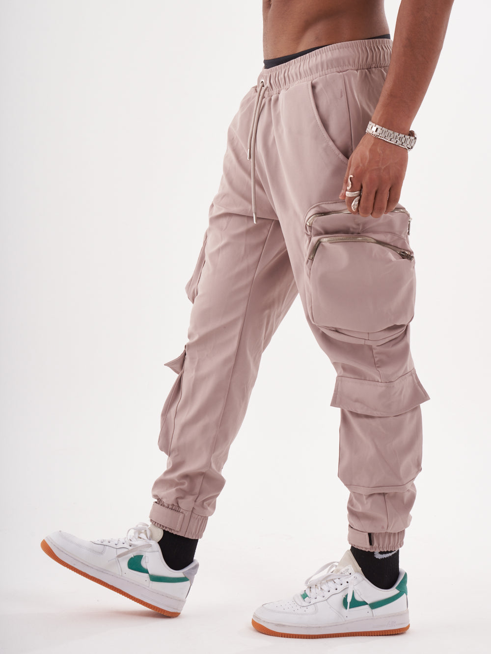 A man wearing SPUNK JOGGERS | MAUVE and sneakers.