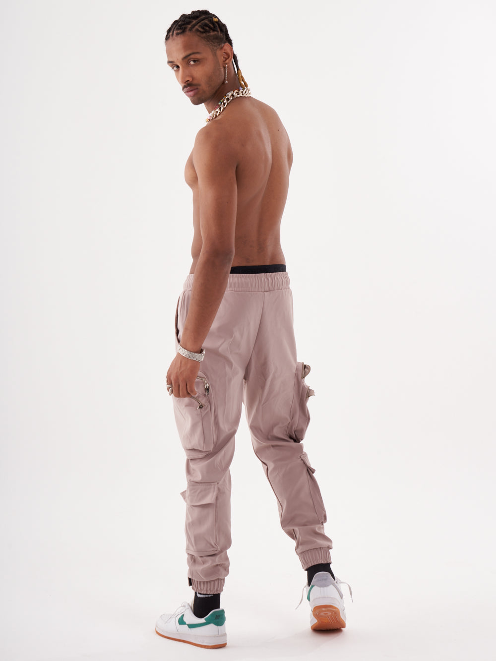 The back of a man wearing SPUNK JOGGERS | MAUVE with drawstring and cargo pockets.