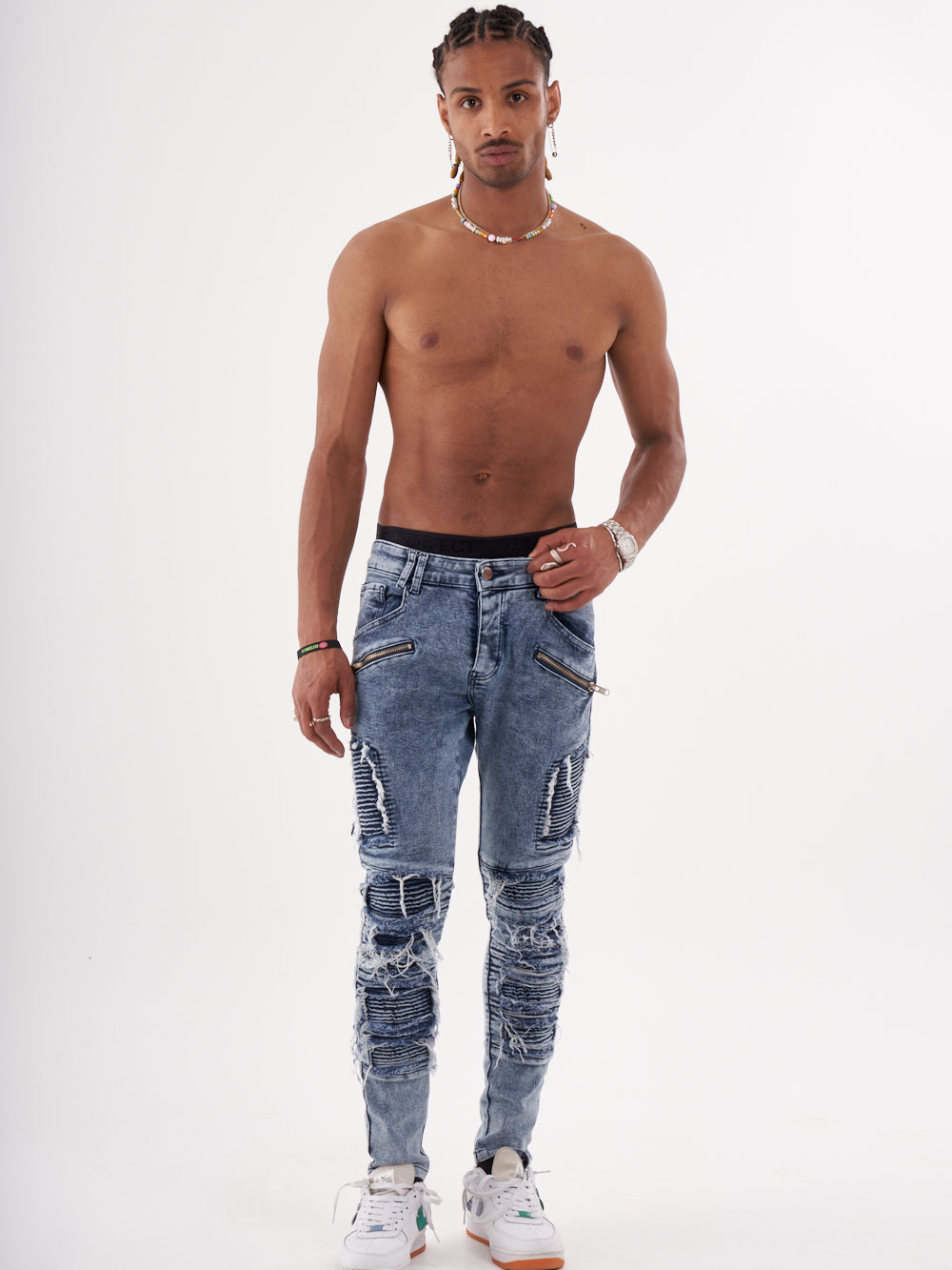 A man in RADICAL jeans posing for a photo.