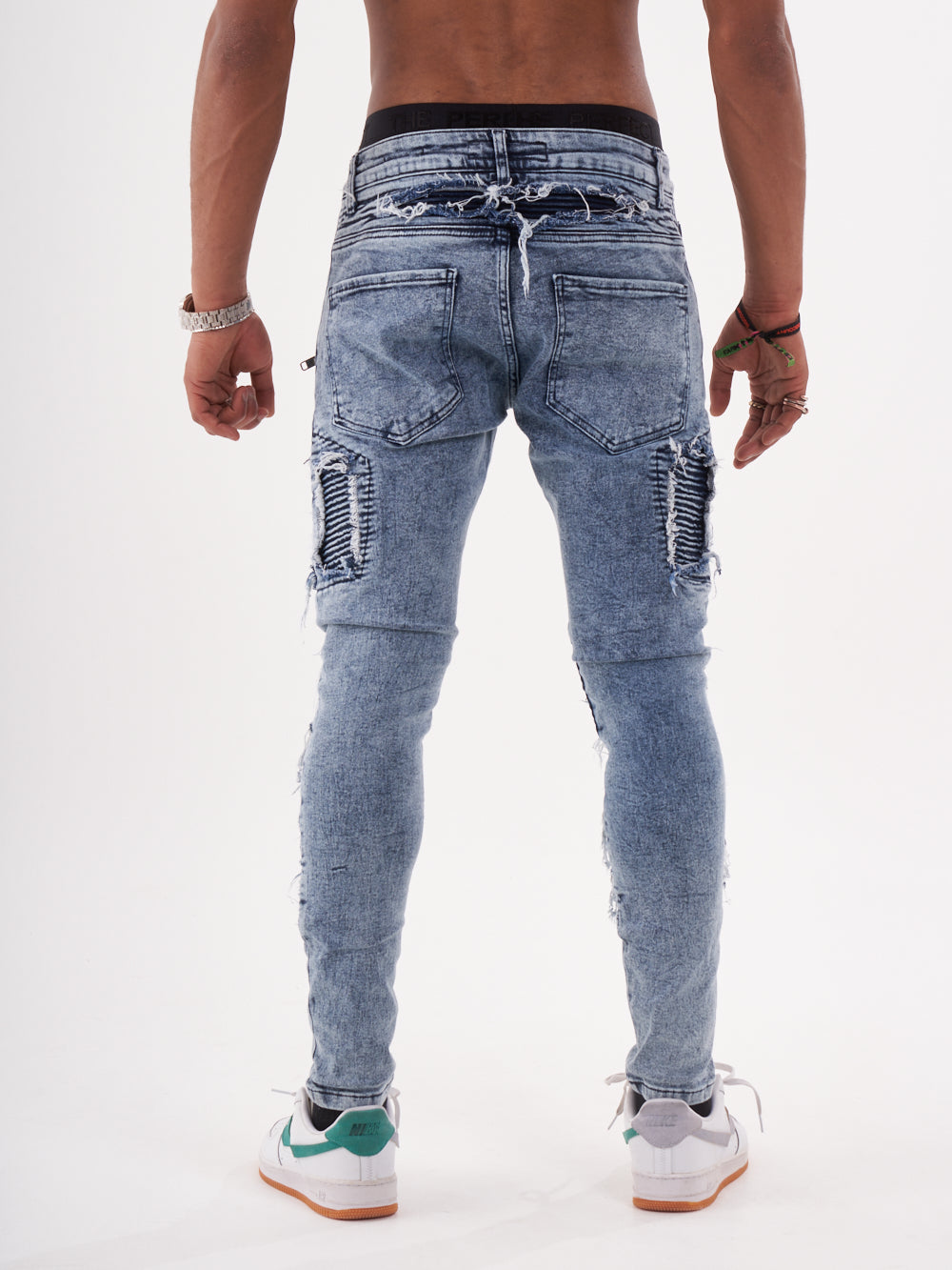 The back view of a man wearing RADICAL jeans.