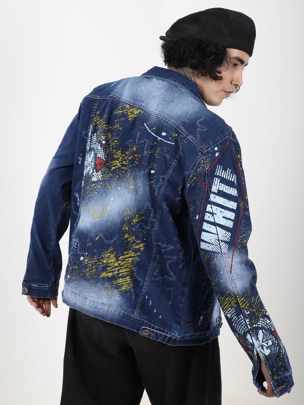The back of a man wearing an OLD PAINTING denim jacket.