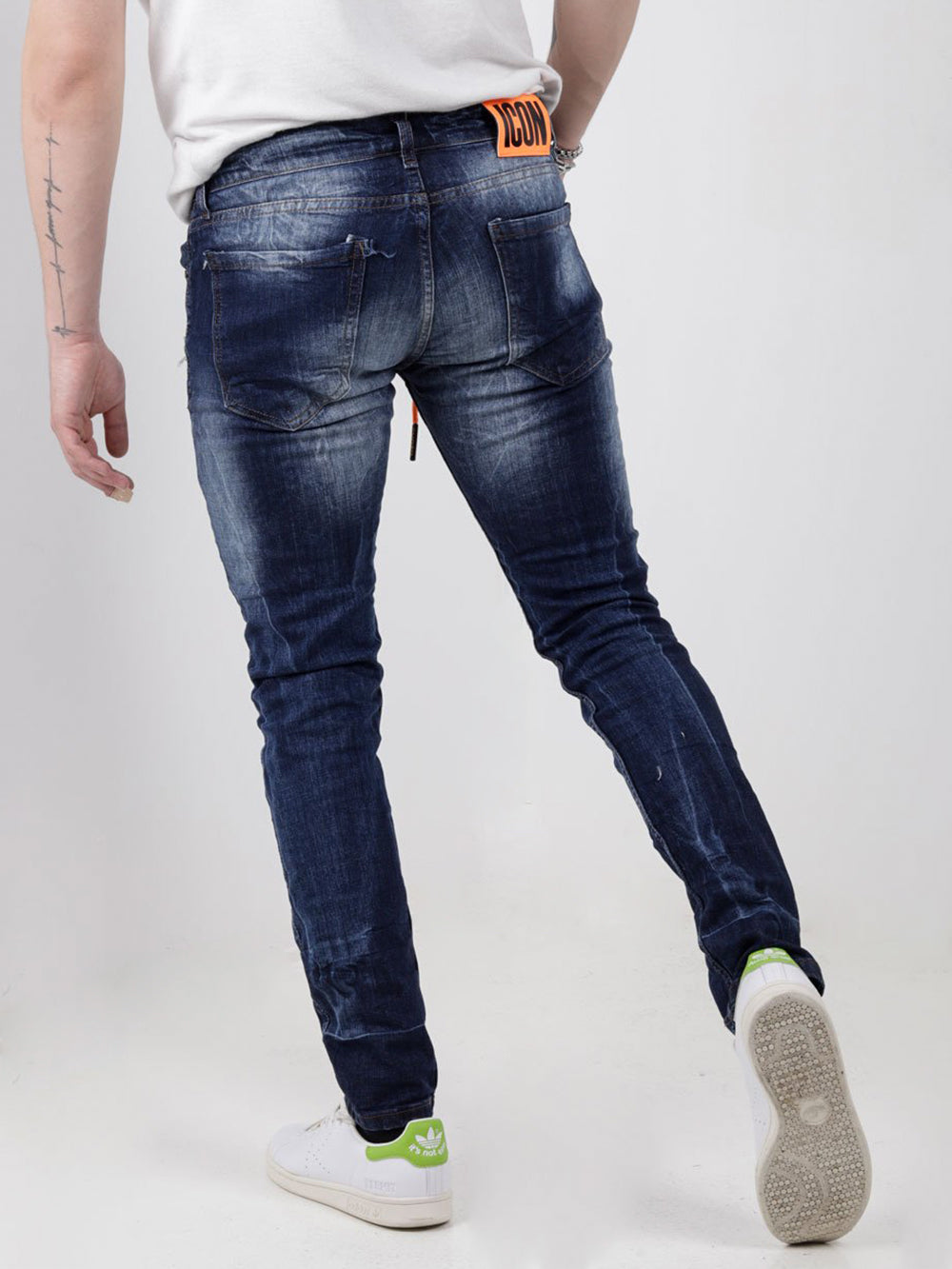 The back view of a man wearing GRAPHITE jeans.