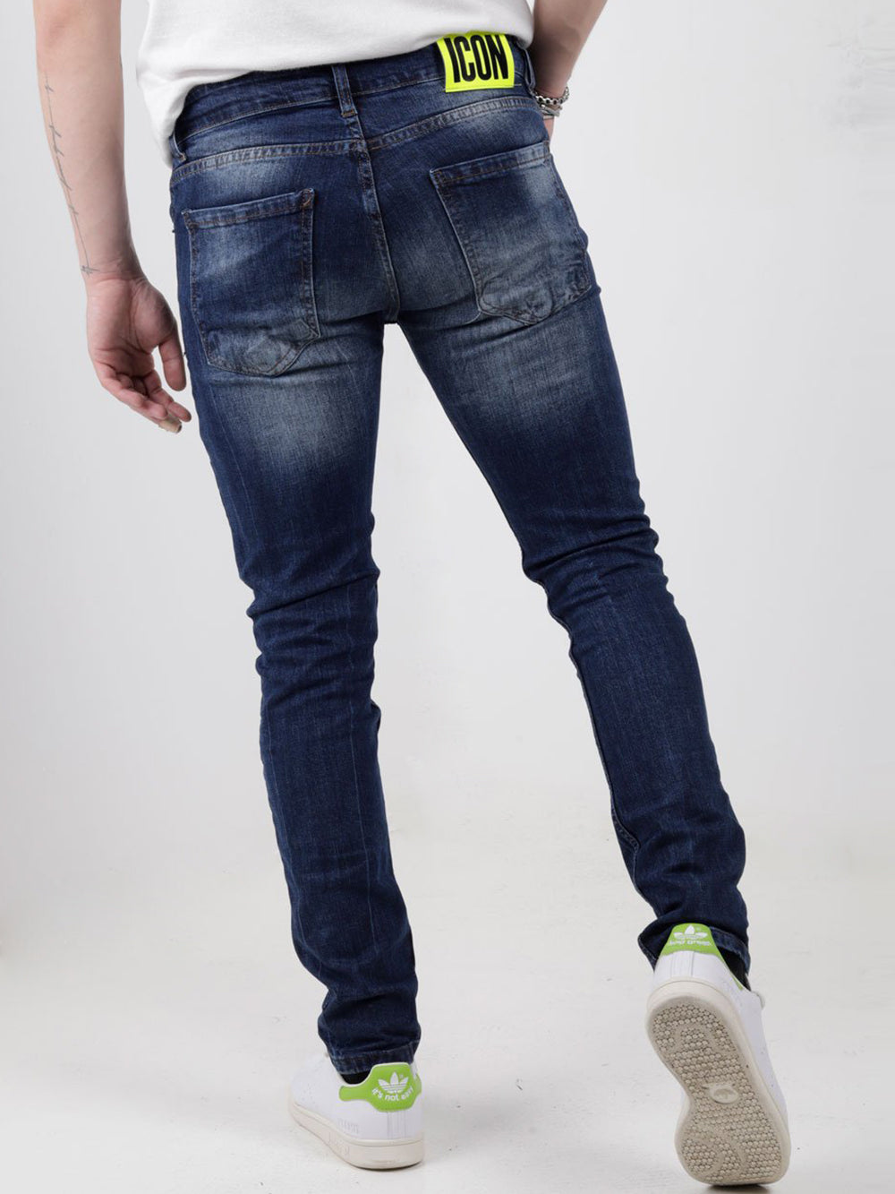 The back view of a man wearing GRAPHITE jeans.