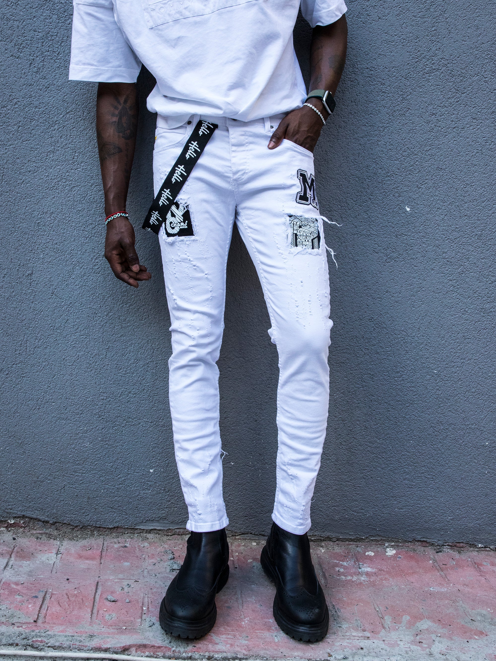 A man wearing white jeans and a black t - shirt MASSIVE.