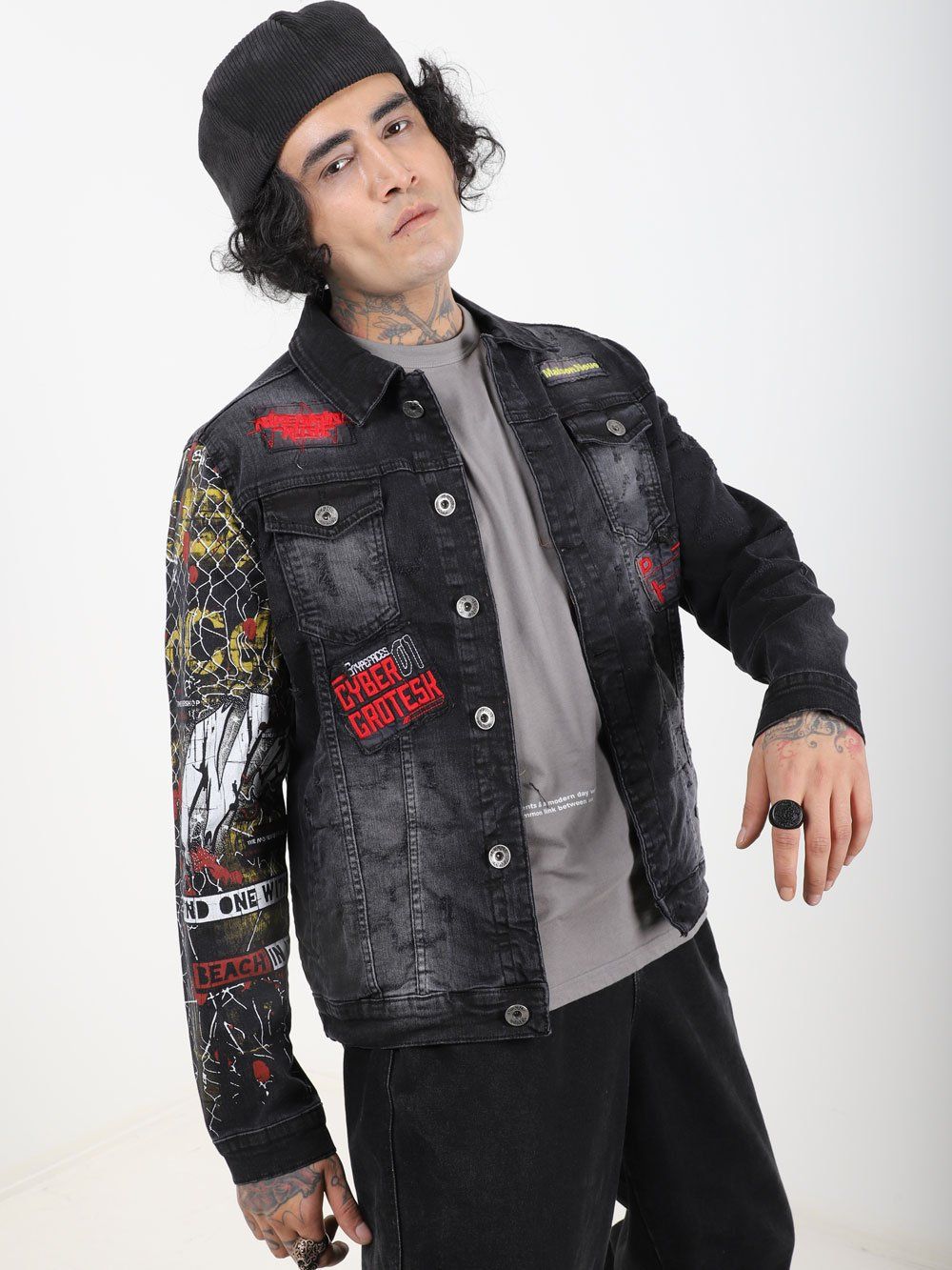A man wearing a JETMAN denim jacket with patches.